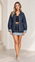 Full front view of model wearing Dark Blue oversized denim jacket with matching skirt
