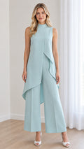 Front view of model wearing a powder blue sleeveless mock neck jumpsuit with asymmetrical overlay