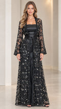 Model wearing black sequin embroidered lace duster jacket over black satin maxi gown with tie belt
