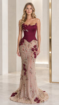 Front full-length view of model in burgundy strapless corset mermaid gown with floral embroidery