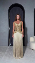 Front full-length view of model wearing Champagne Gold strapless embellished fringe maxi evening dress