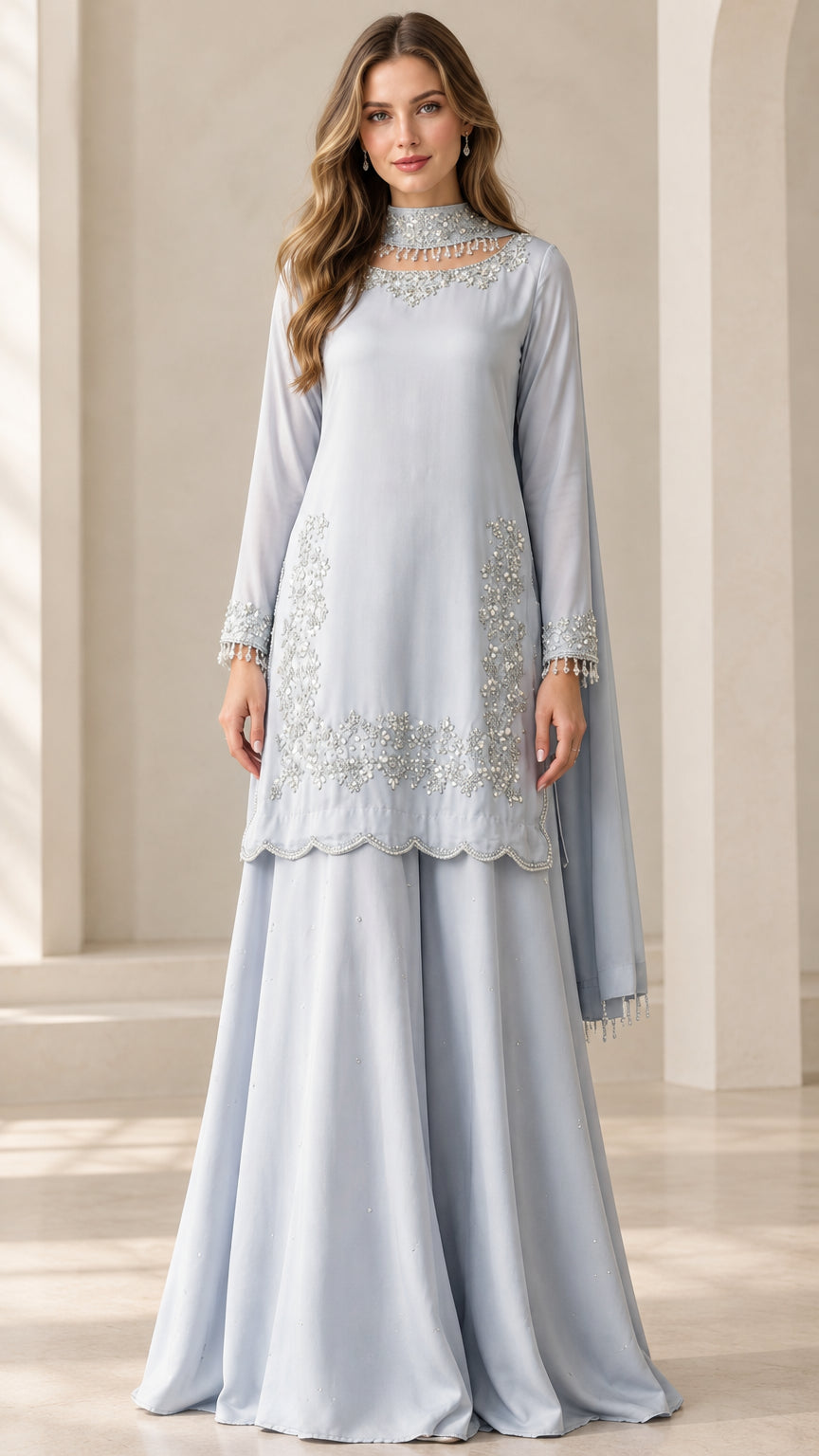 Front view of woman wearing Ice Blue embellished high-neck sharara suit set