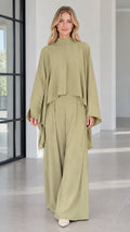 Front view of woman wearing sage green mock neck cape top and matching wide leg pants set