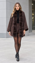 Front full-length view of woman wearing brown faux fur trim cable knit cardigan coat
