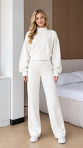 Front full view of woman wearing Off White 2-piece zip-up sweatshirt and wide leg pants set