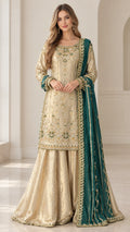 Full front view of model wearing gold embroidered sharara suit with dark green dupatta