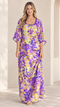 Front view of model wearing purple and yellow floral kaftan maxi dress with crochet lace neckline
