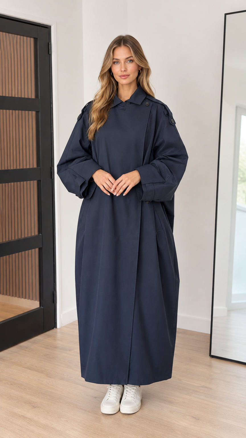 Front full-length view of woman wearing navy blue oversized maxi trench coat