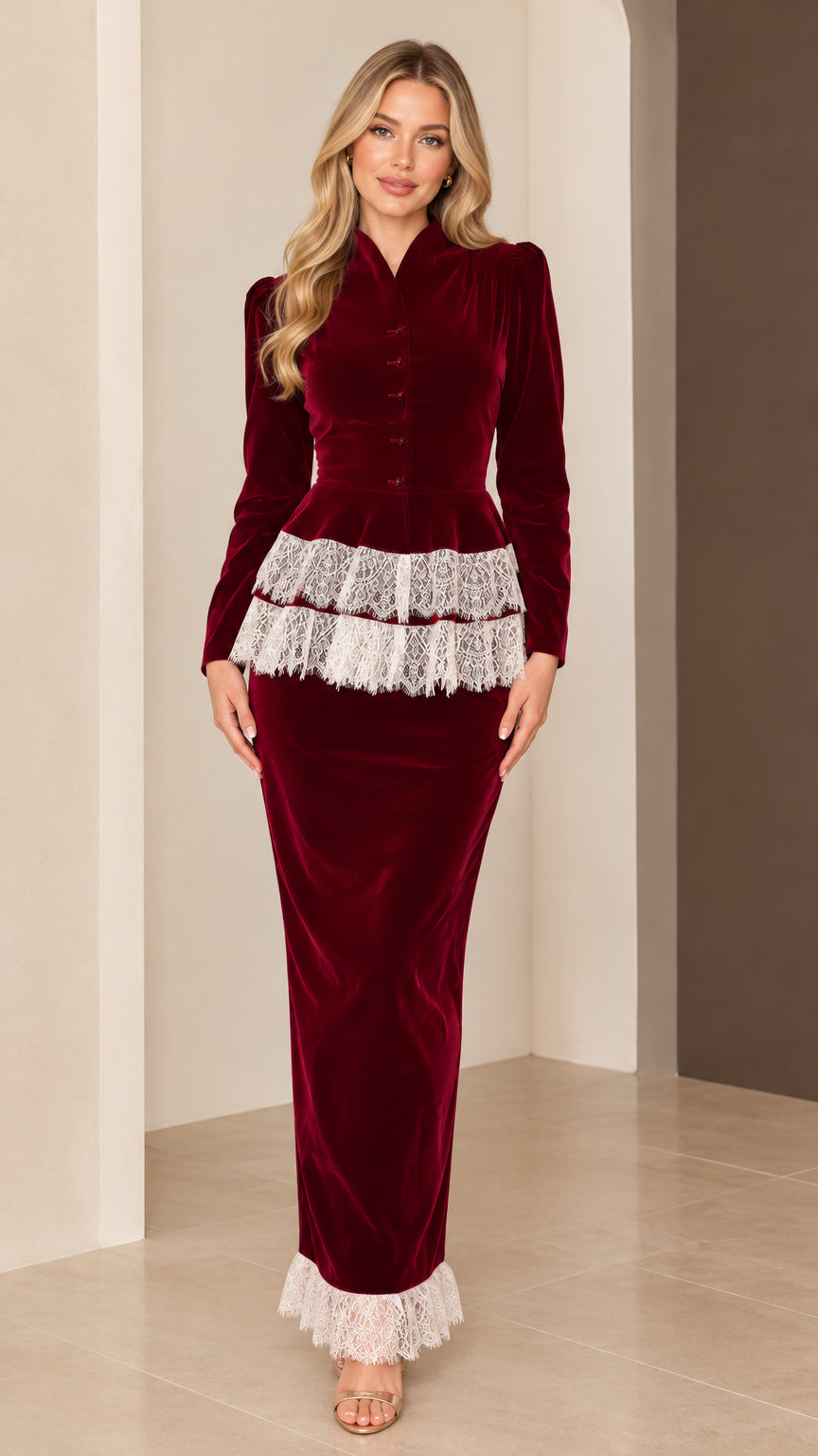 Front full-length view of model wearing burgundy velvet peplum maxi dress with white lace trim