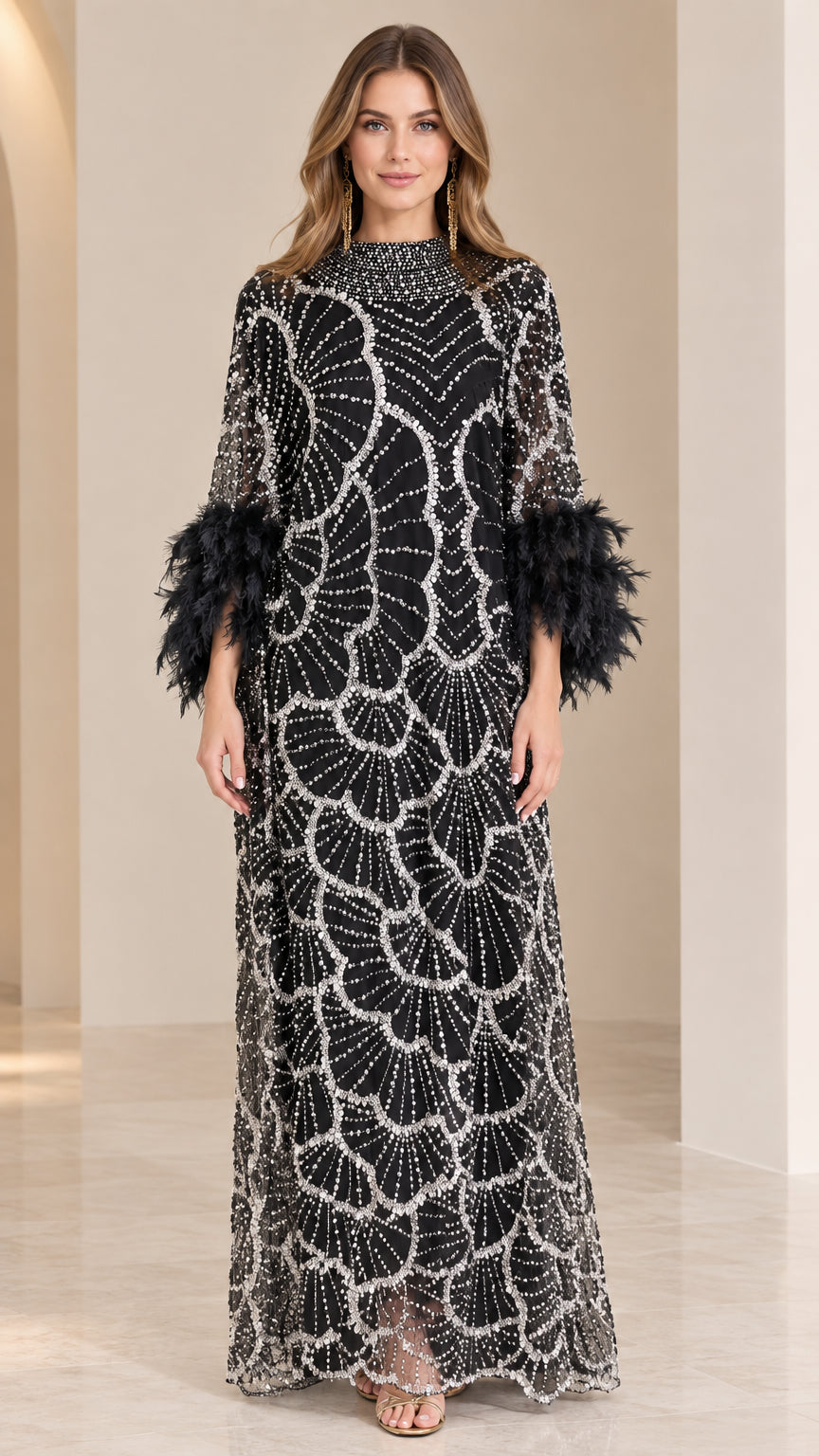 Front full-length view of model wearing black beaded maxi dress with feather cuffs