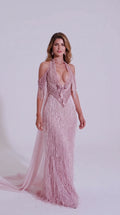 Front view of model wearing Blush Pink beaded fringe halter evening gown with train