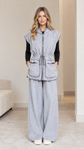 Front full-length view of model wearing heather grey sleeveless hooded vest and wide-leg pants set