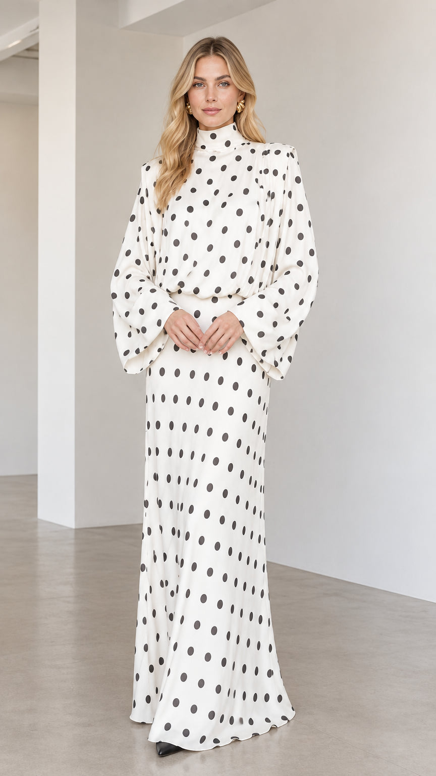 Front view of model wearing white high neck polka dot long sleeve maxi dress