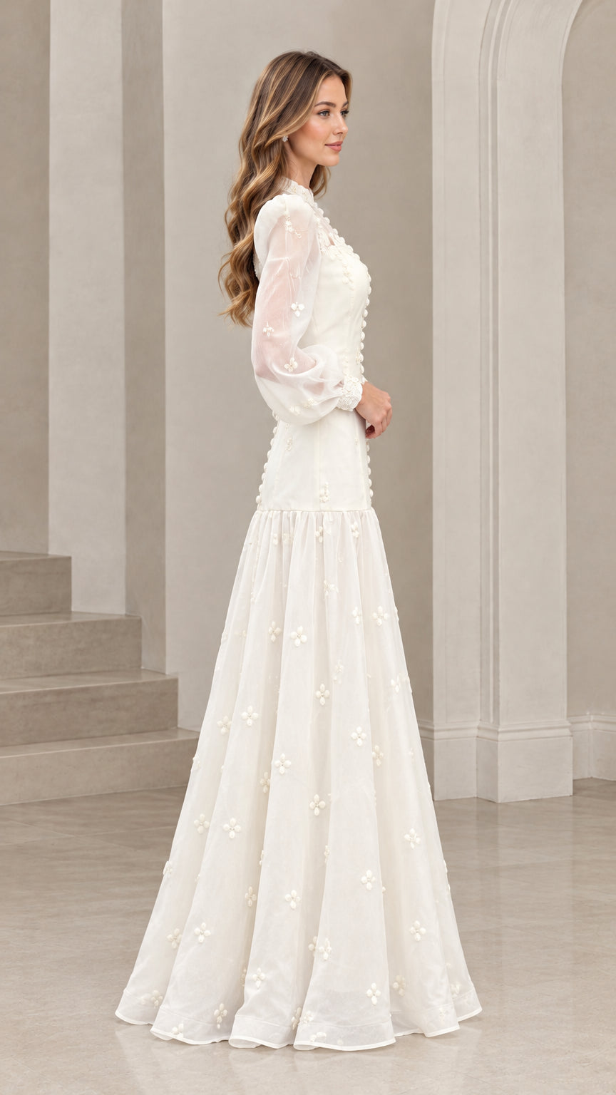 Side profile view of woman wearing ivory long sleeve lace maxi dress