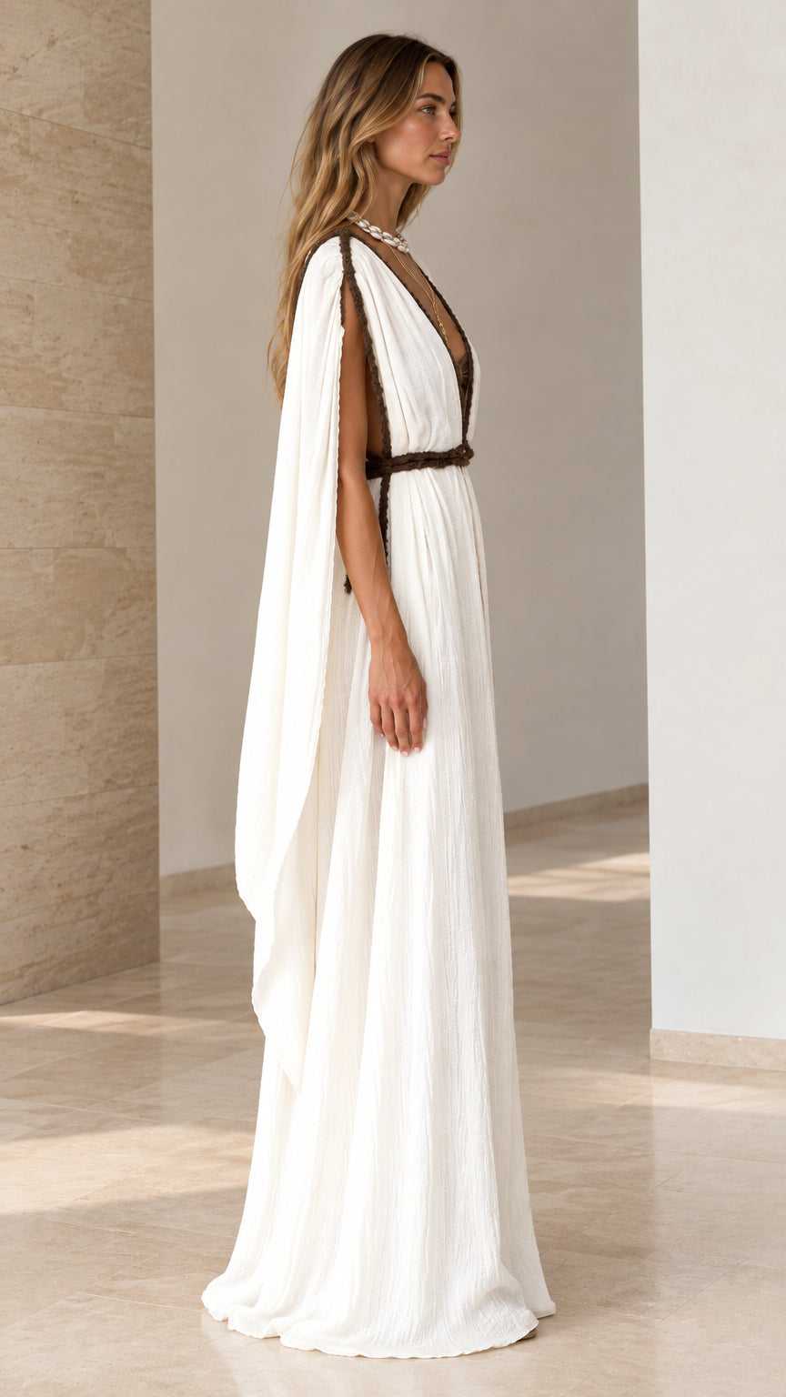 Side profile of white cape sleeve maxi dress showing flowing drape