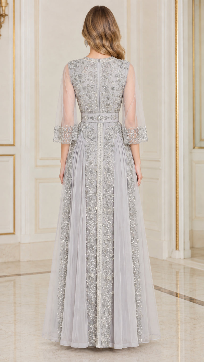 Back full-length view of silver grey embellished evening gown with sheer sleeves