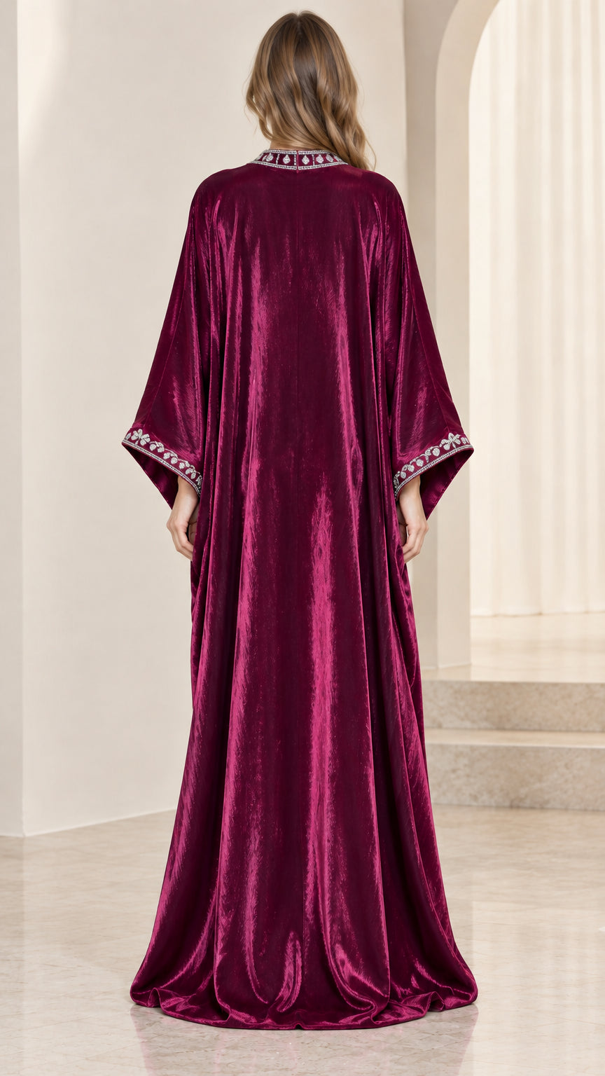 Back view of woman wearing elegant floor-length burgundy velvet kaftan dress
