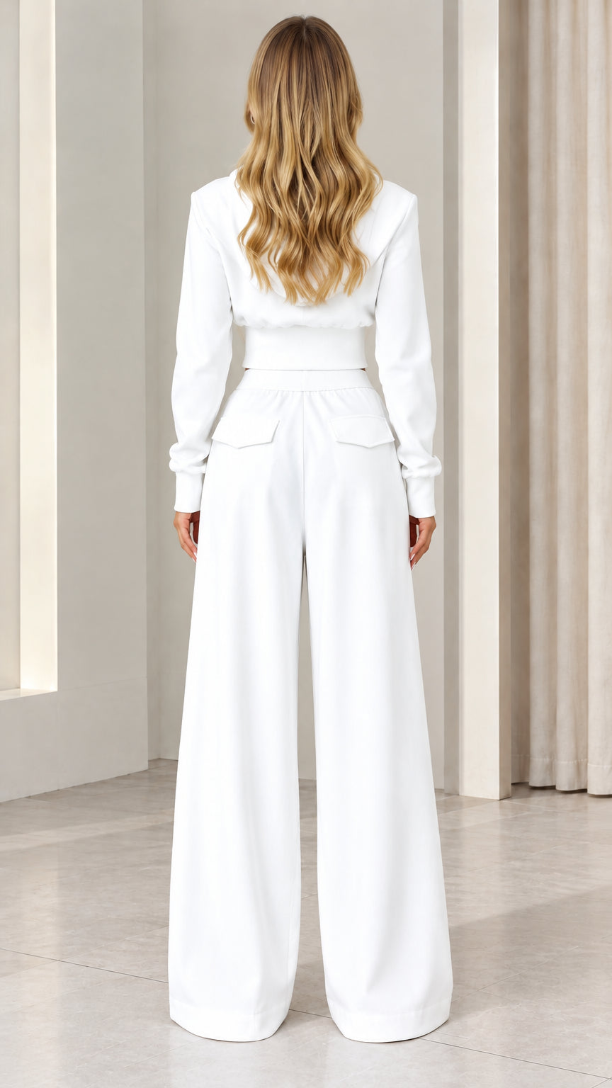 Back view of woman in white matching two-piece pant set