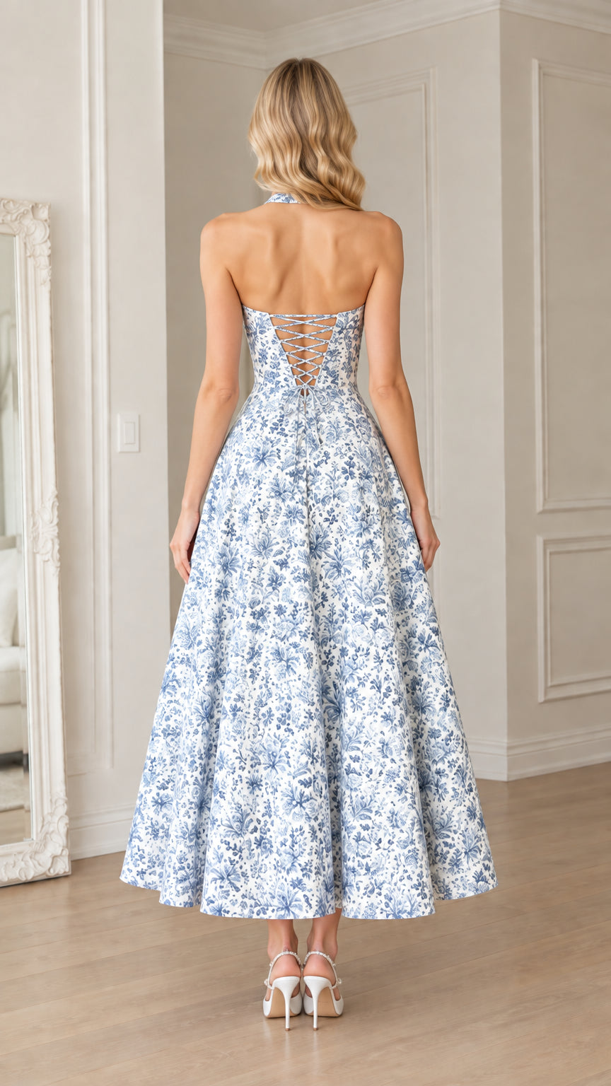 Back view of woman showing the lace-up tie back of the blue floral maxi dress