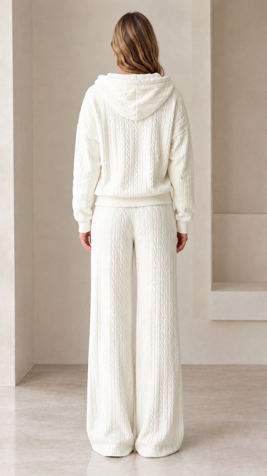 Back view of woman wearing white cable knit hoodie and wide leg pants set