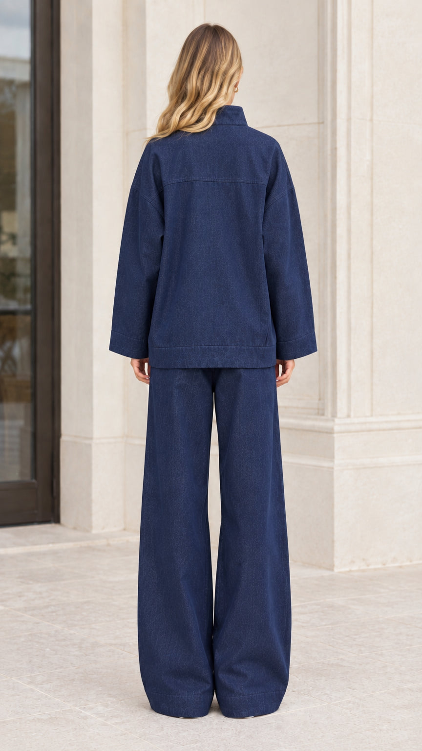 Back view of women's navy blue relaxed matching two-piece set