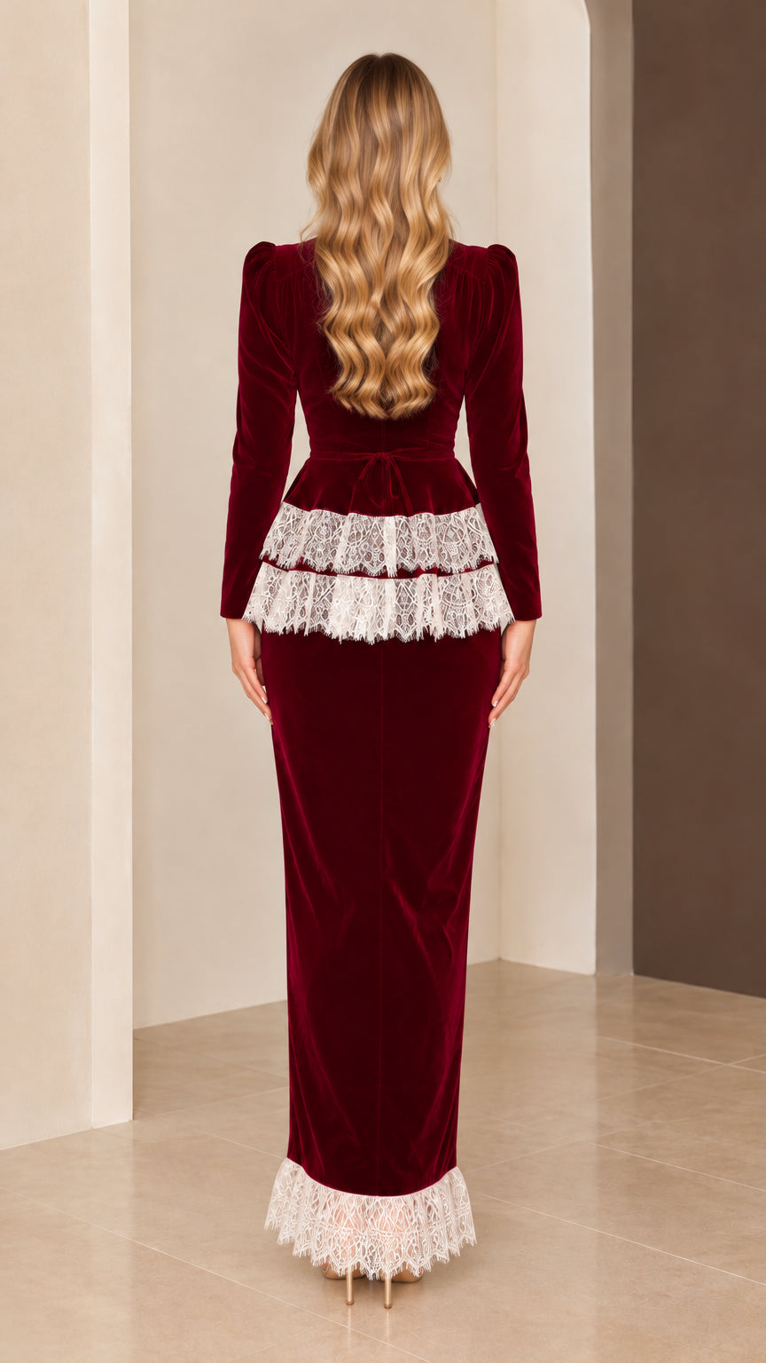 Back view of model in elegant burgundy velvet evening dress showing sleek tailored fit