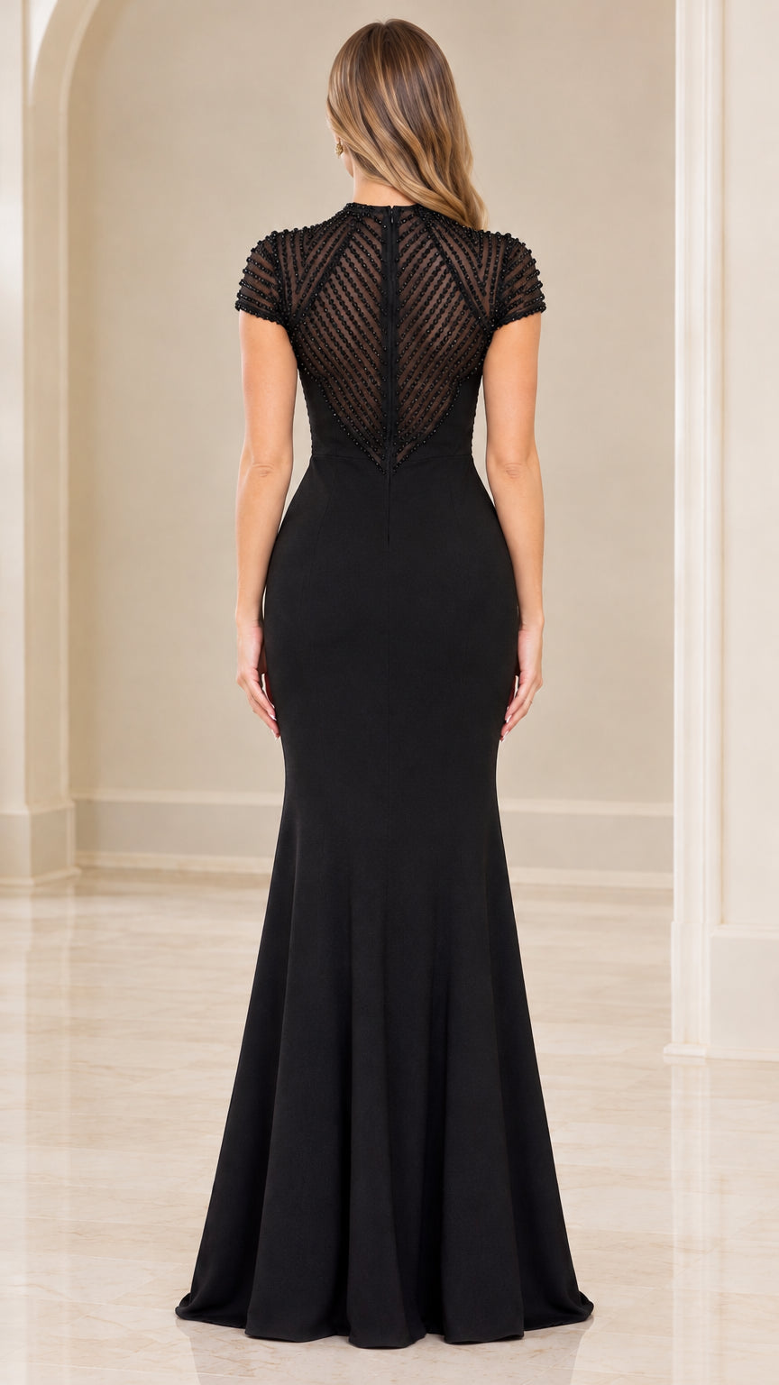 Back view of black evening gown showing sheer beaded illusion back detail