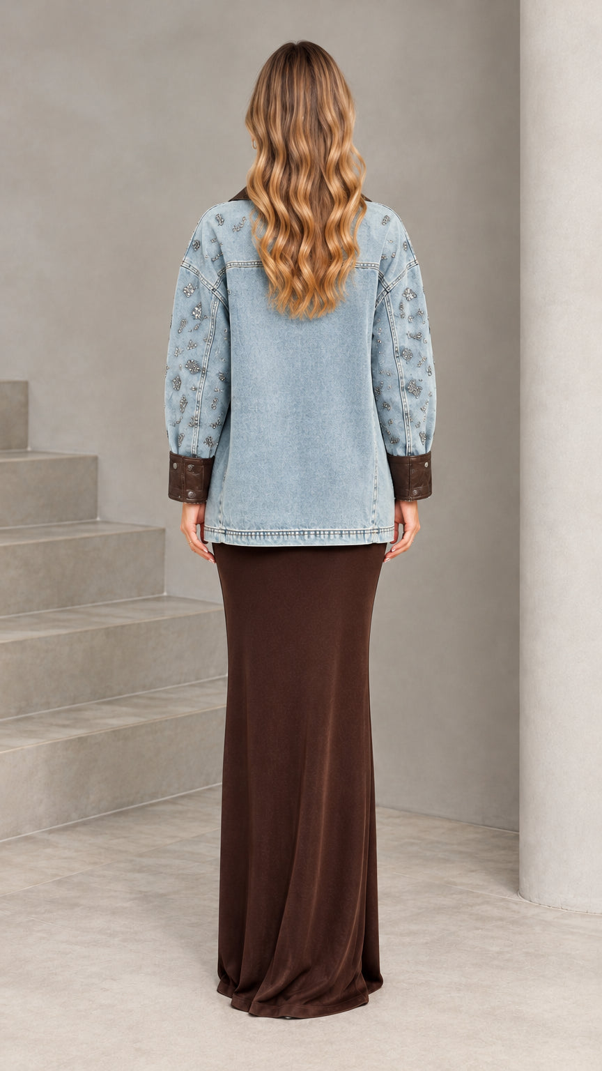 Back view of model wearing Light Blue oversized embellished denim jacket