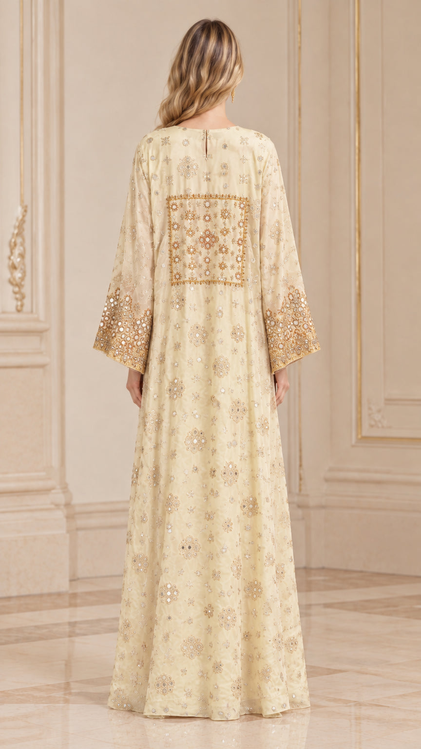 Back view of woman wearing Champagne kaftan dress showing intricate embroidered back panel