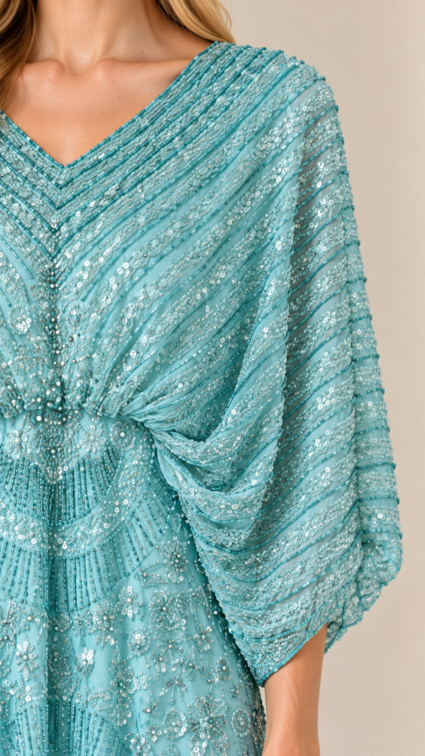 Close-up of aqua sequin detailing and draped V-neck bodice