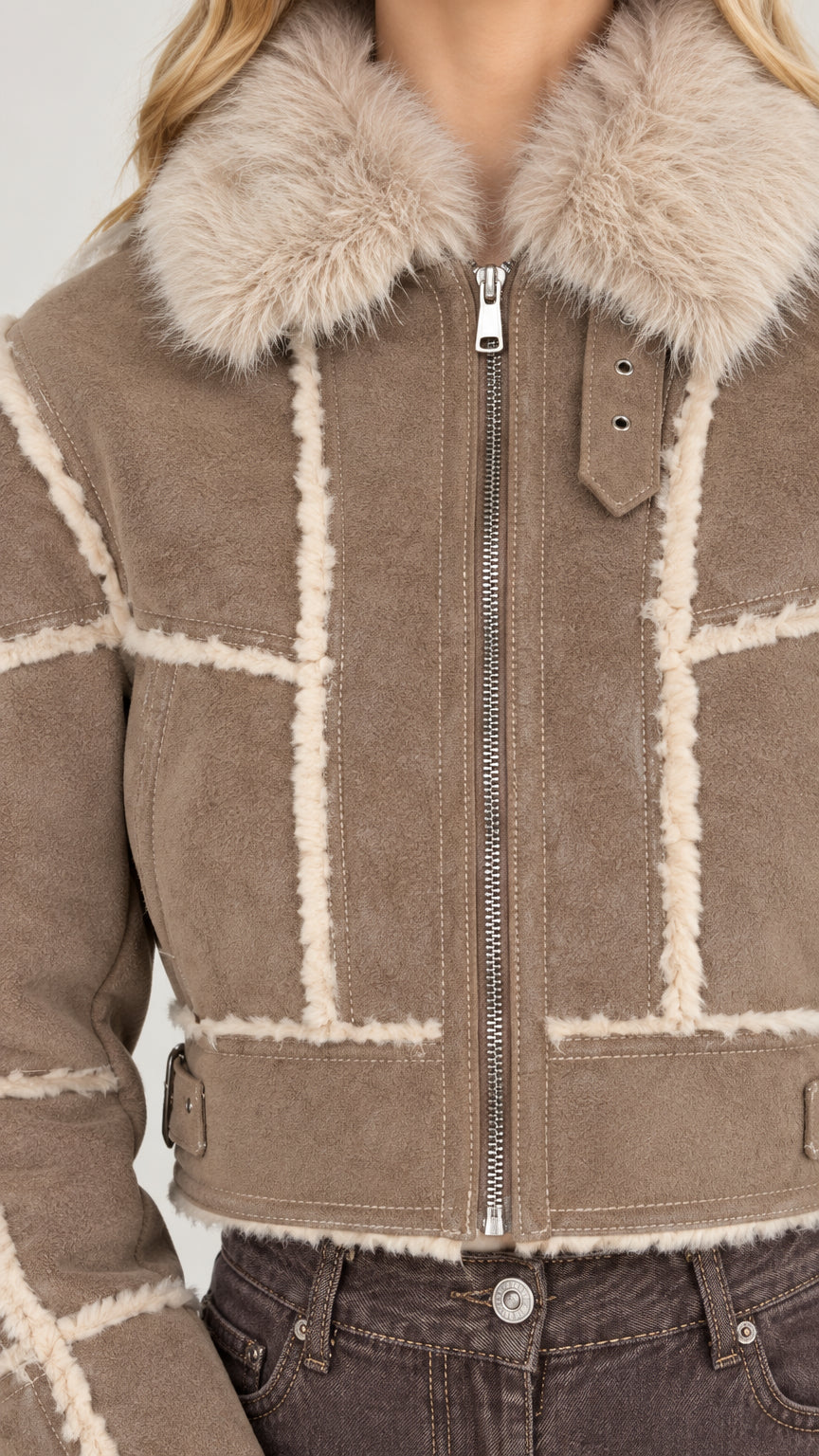 Close-up detail of plush fur collar, zipper, and fleece trim on taupe faux suede jacket