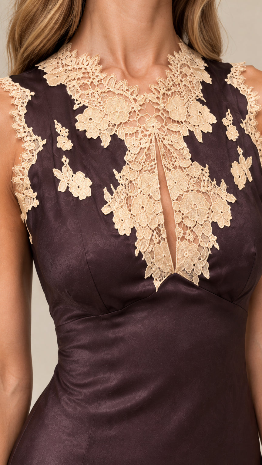 Close-up of intricate crochet floral lace appliqué neckline on espresso satin dress