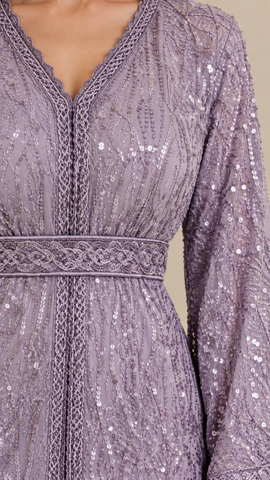 Close-up detail of V-neckline embroidery, braided trim, and delicate sequin pattern on Lilac dress