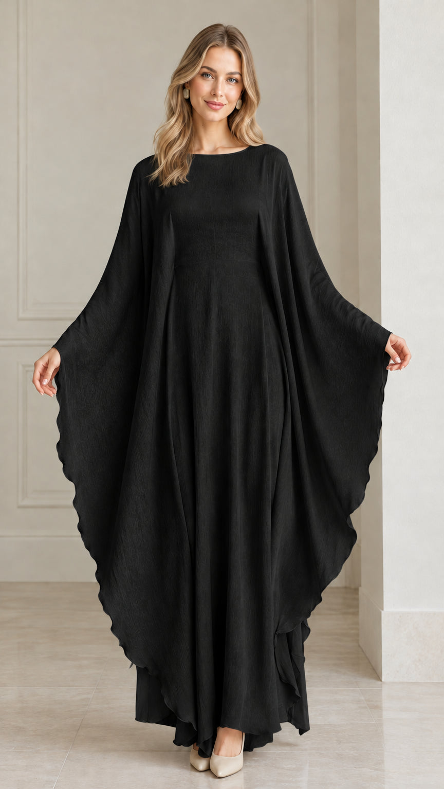 Front view of woman wearing black draped cape sleeve evening kaftan dress