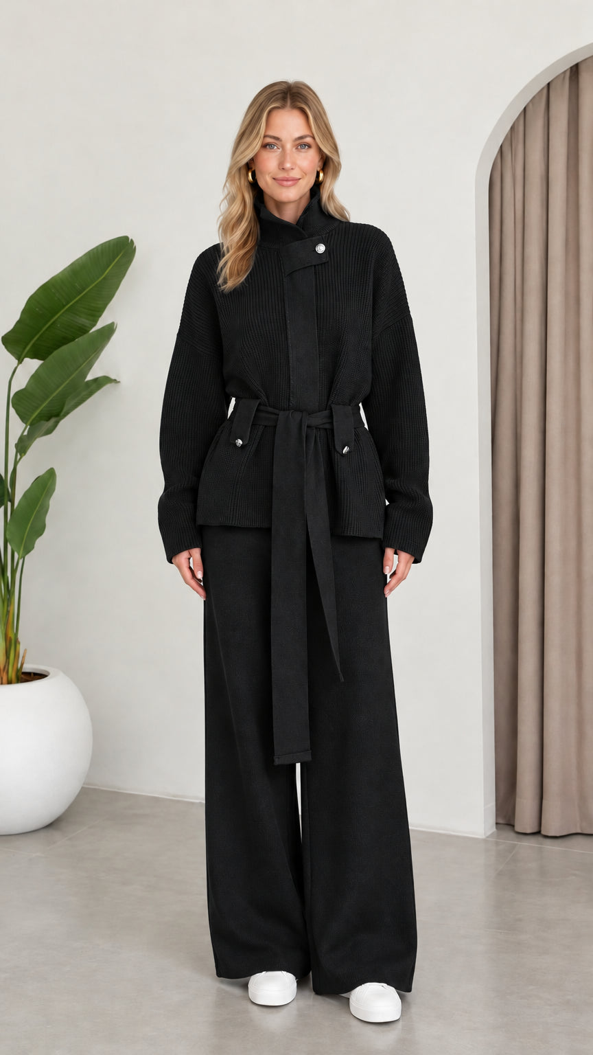 Full front view of model wearing the Black ribbed knit belted two-piece set