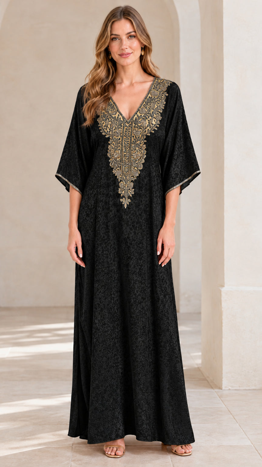Full front view of woman wearing black embroidered kaftan maxi dress