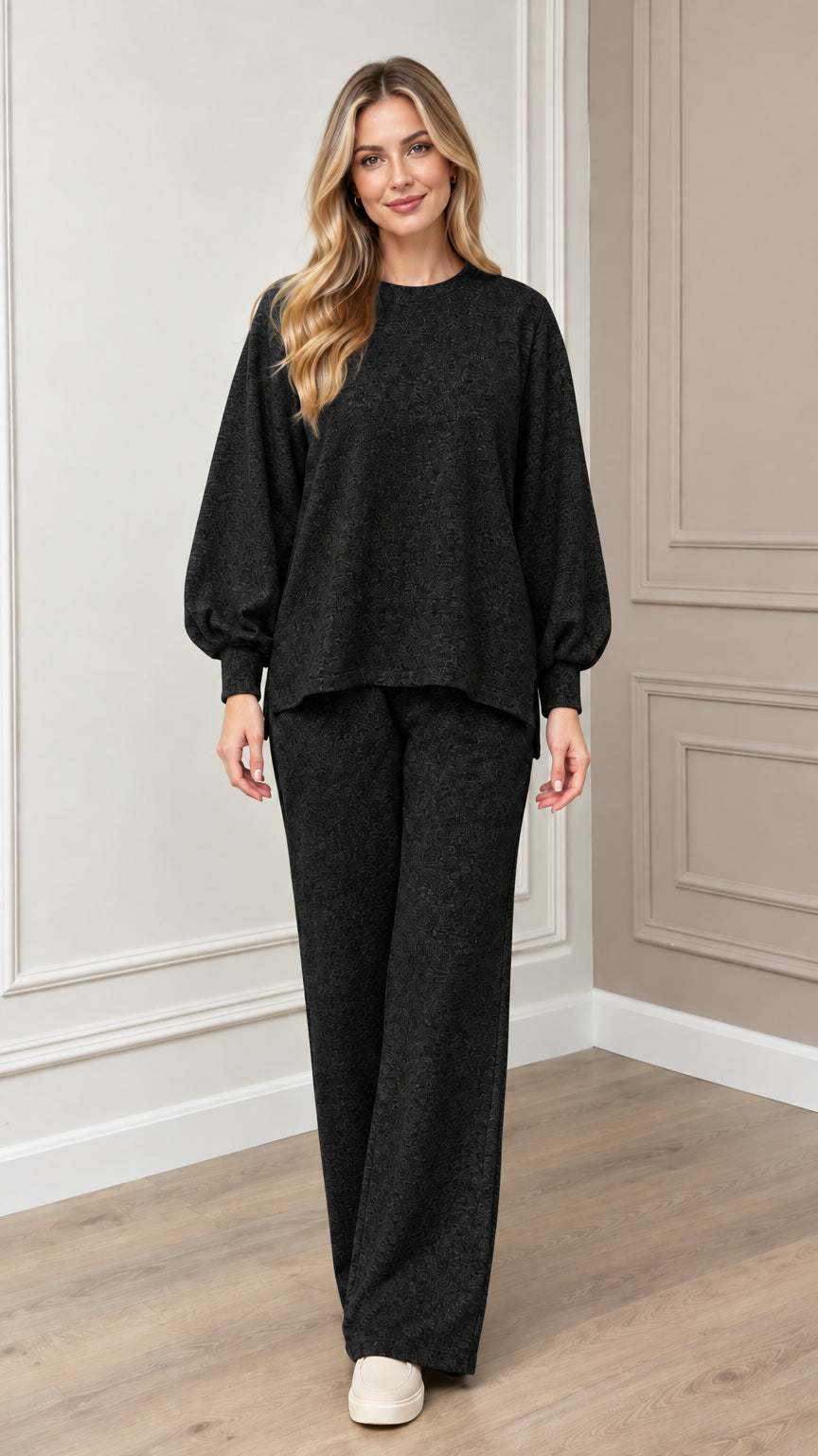 Model wearing black textured knit two-piece lounge set