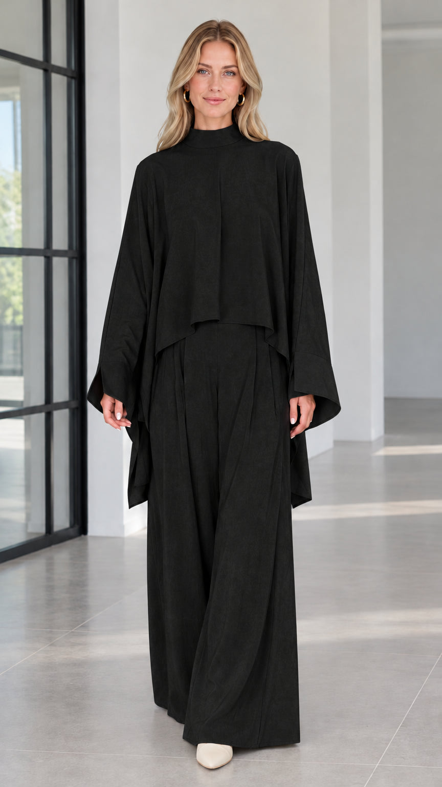 Front view of elegant black mock neck cape top and wide leg palazzo pants set
