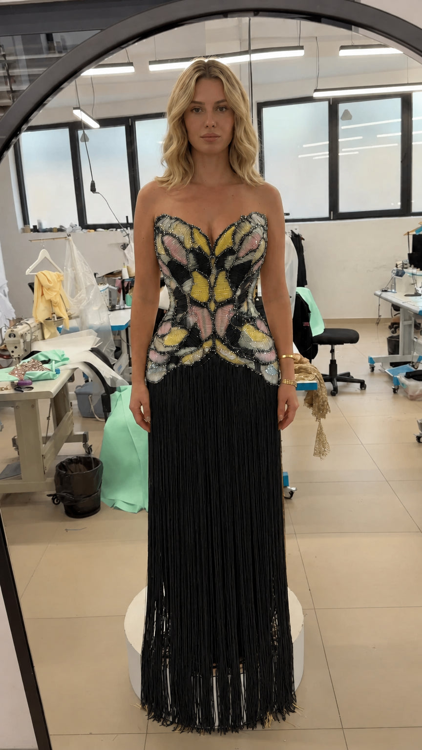 Front view of strapless beaded corset fringe evening gown in black