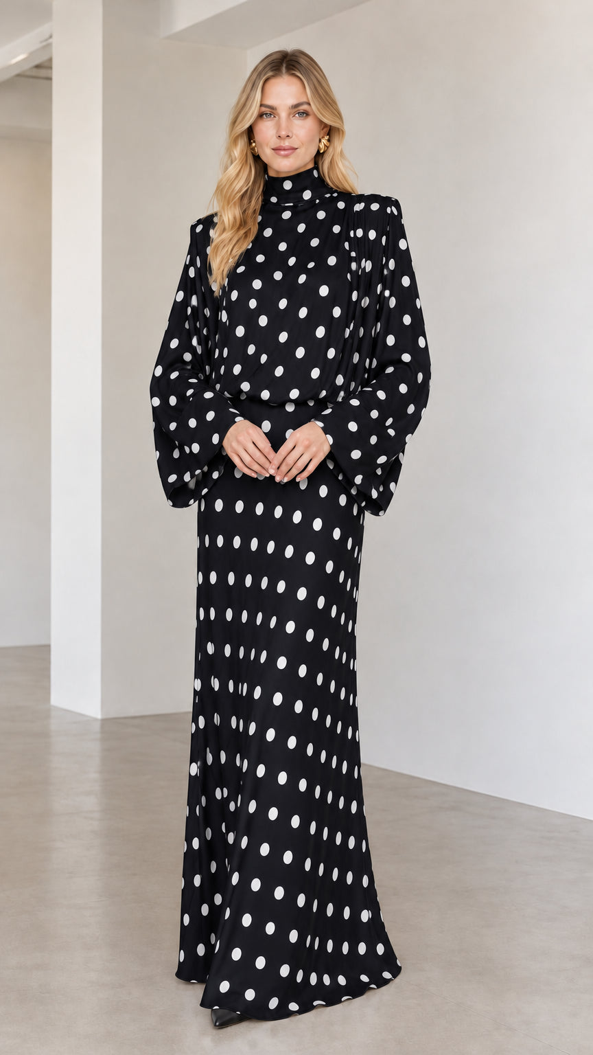 Model wearing black polka dot long sleeve high neck maxi dress
