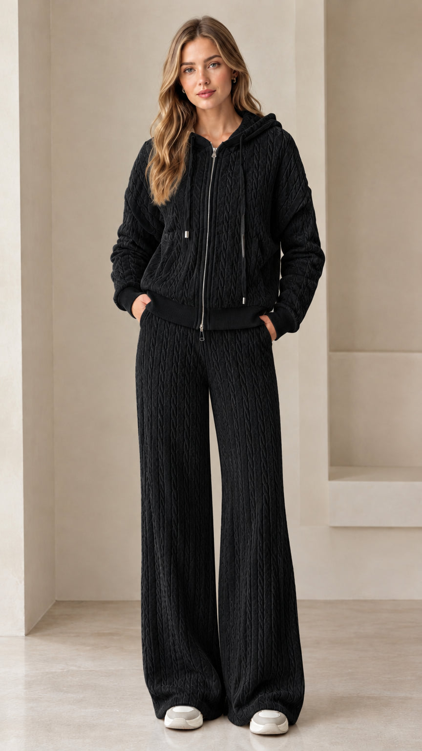 Full-length view of woman wearing black cable knit zip-up hoodie and wide leg lounge pants