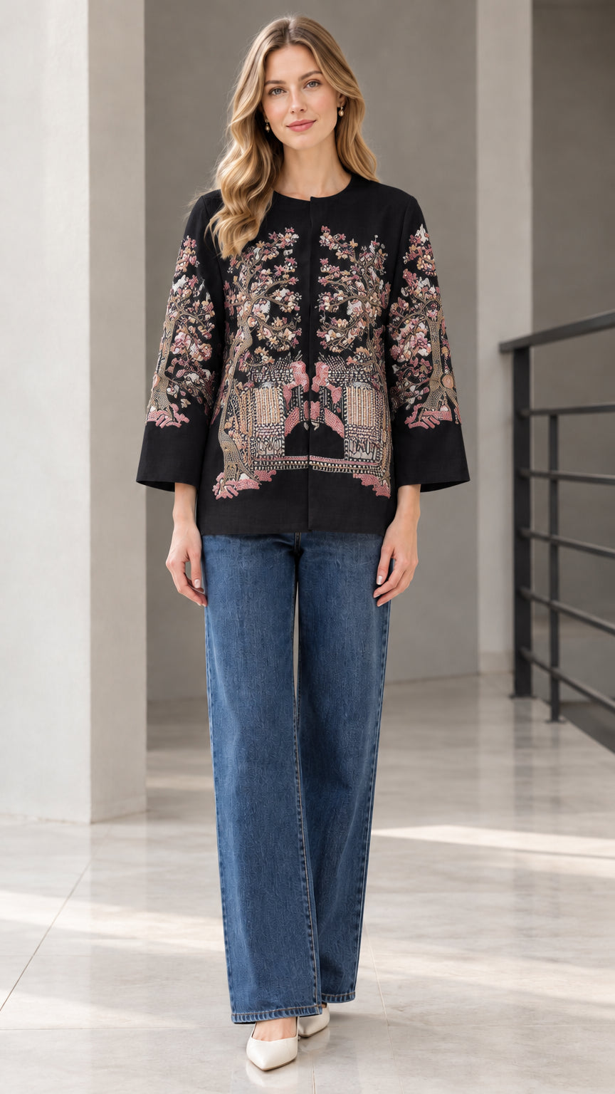 Black floral embroidered collarless jacket modeled with blue jeans