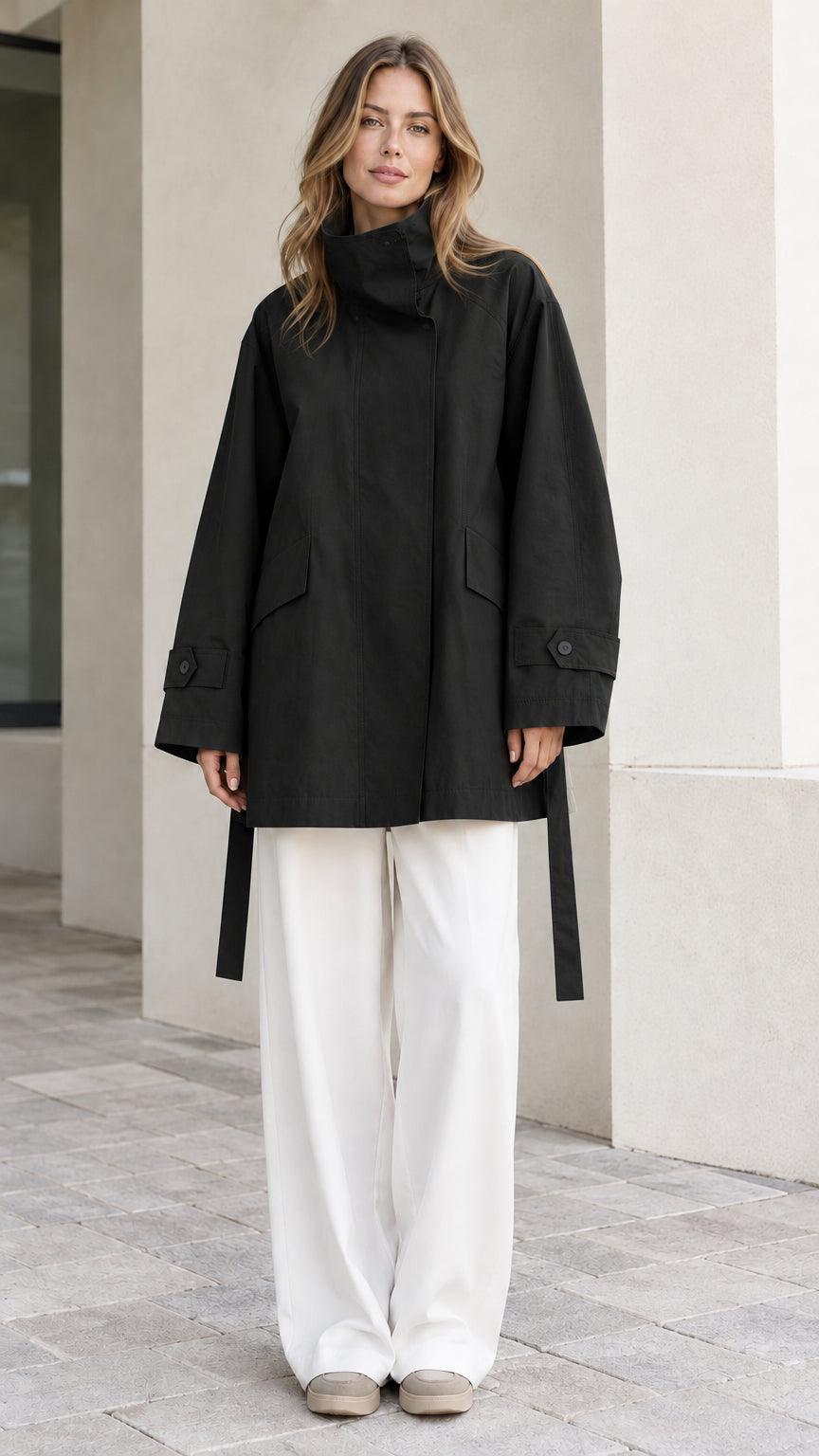 Front view of model wearing Black high-neck relaxed belted trench jacket