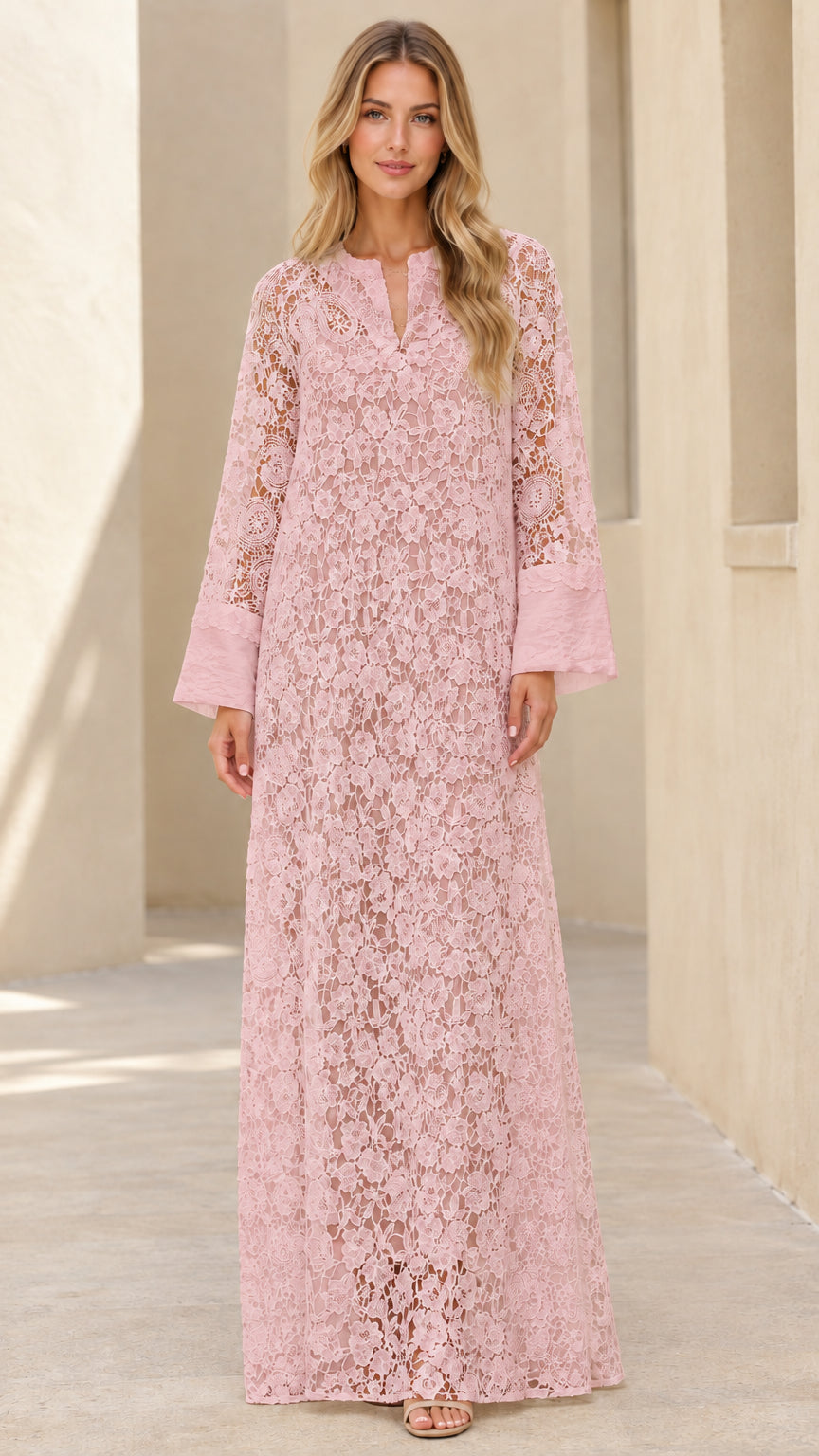 Woman wearing blush pink floral lace long sleeve maxi dress