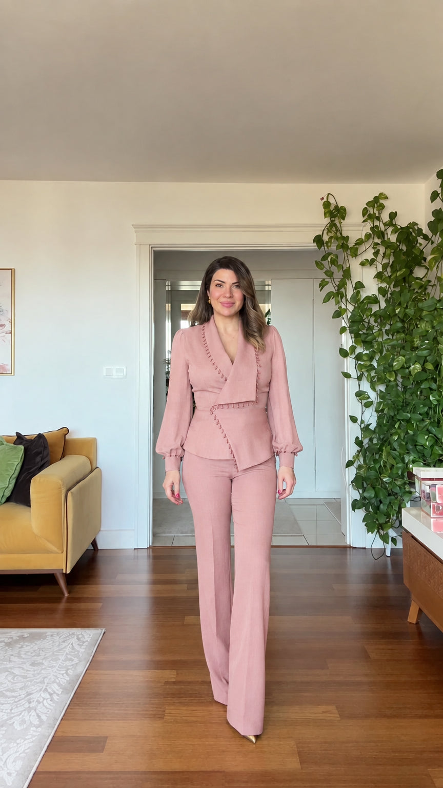 Full-length front view of woman wearing blush pink beaded blazer and wide leg pants suit set