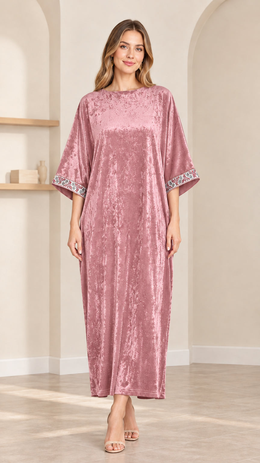 Front view of model wearing dusty pink crushed velvet kaftan maxi dress