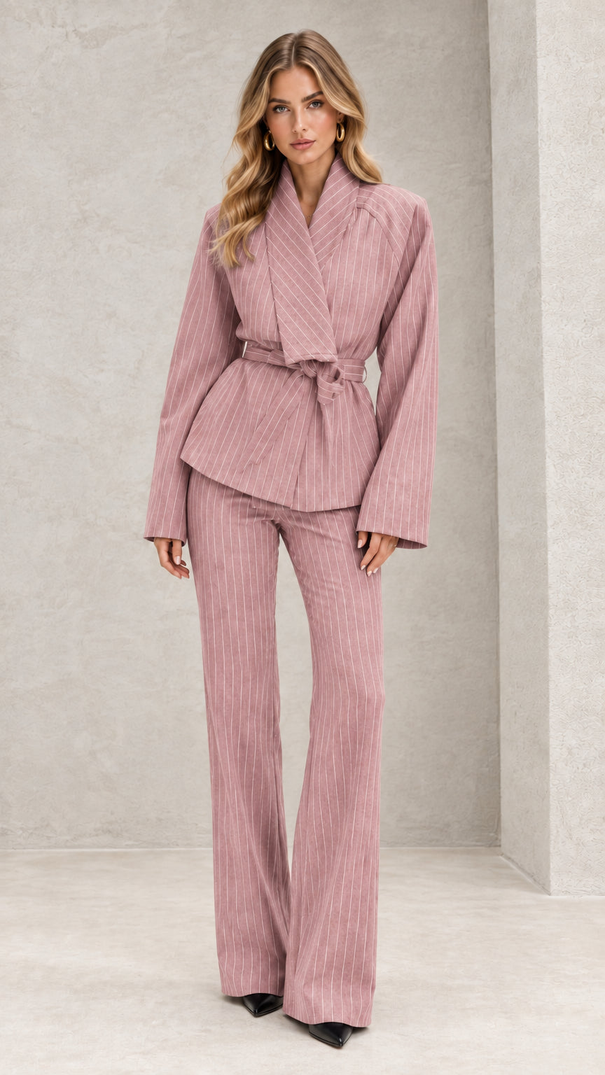 Front view of model wearing dusty pink pinstripe belted wrap suit set