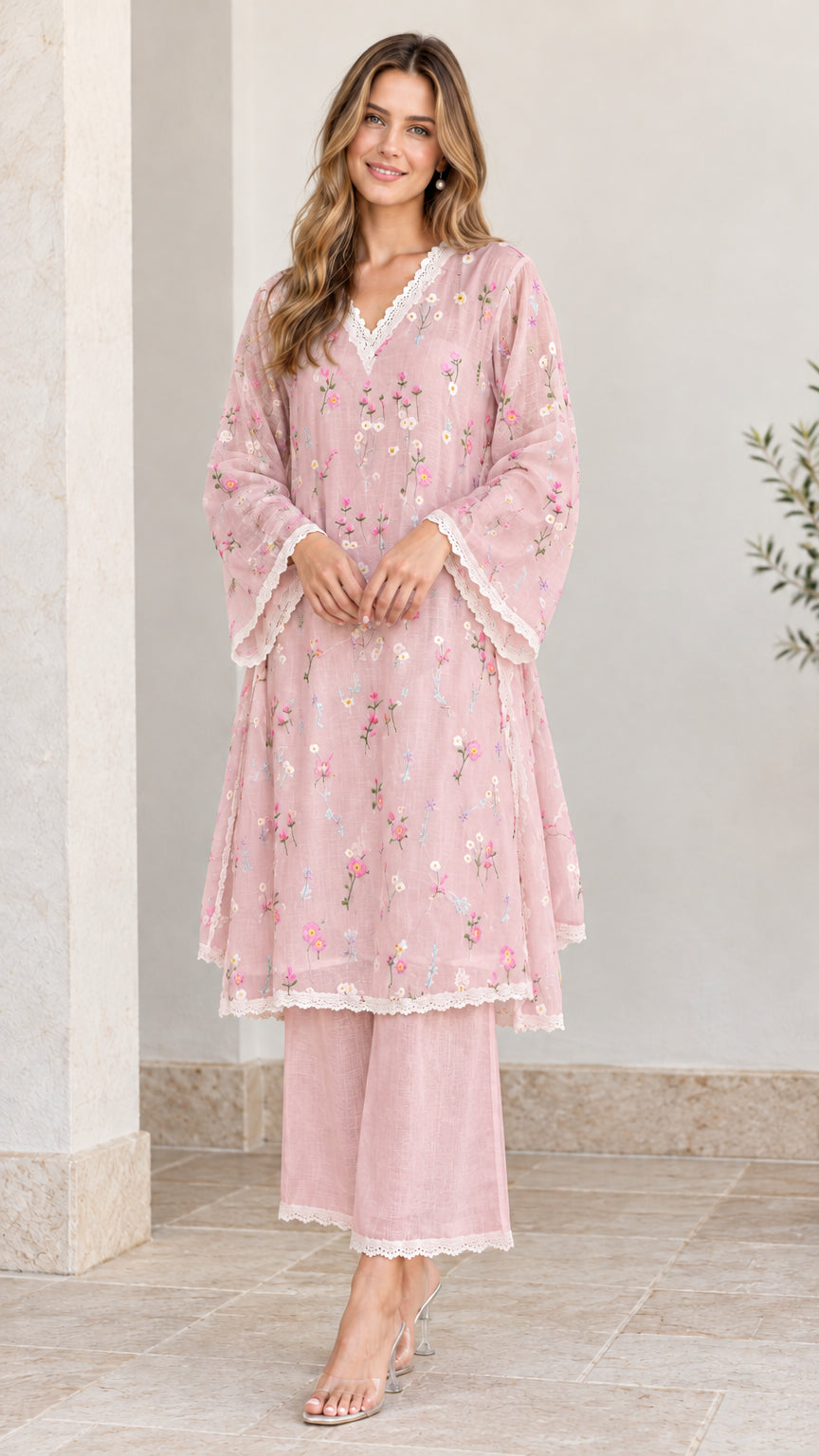 Full-length view of woman wearing dusty pink floral embroidered tunic and pant set