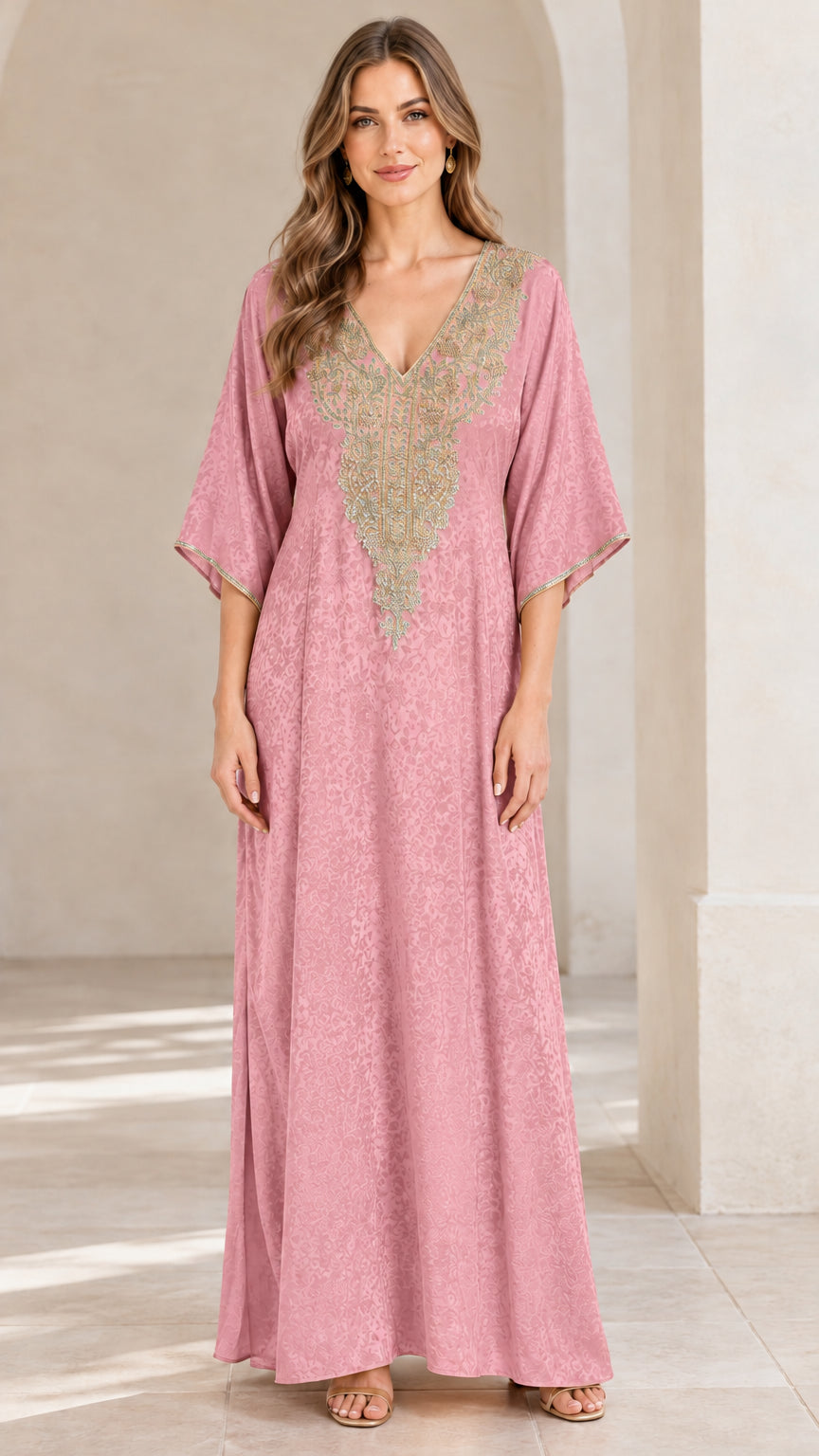 Full front view of woman wearing dusty pink embroidered kaftan maxi dress