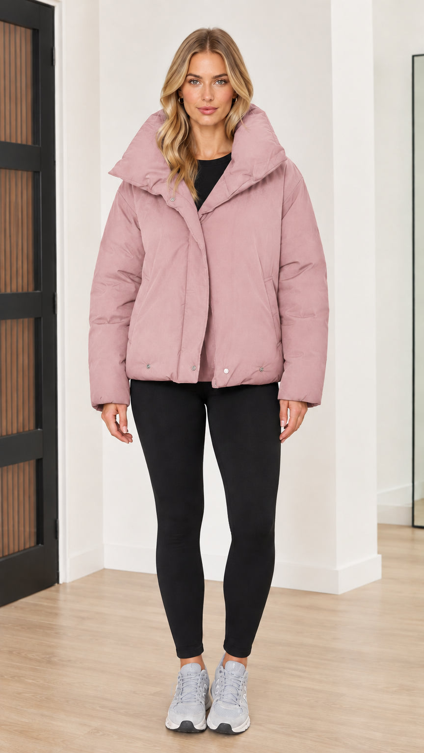 Front view of woman wearing dusty pink funnel collar puffer jacket
